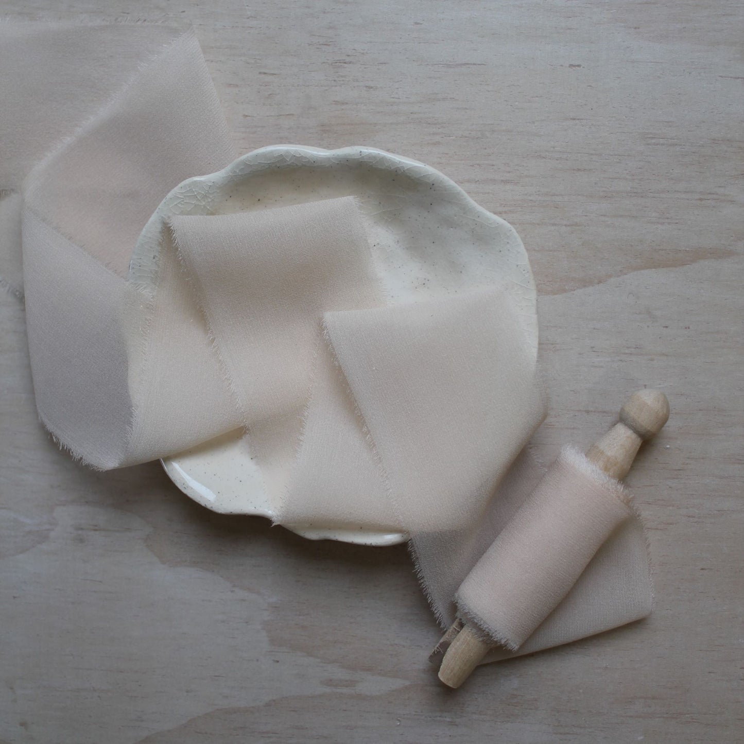 Close-up of the 'Touch of Pink' silk chiffon ribbon, highlighting its sheer, lightweight fabric and frayed edges