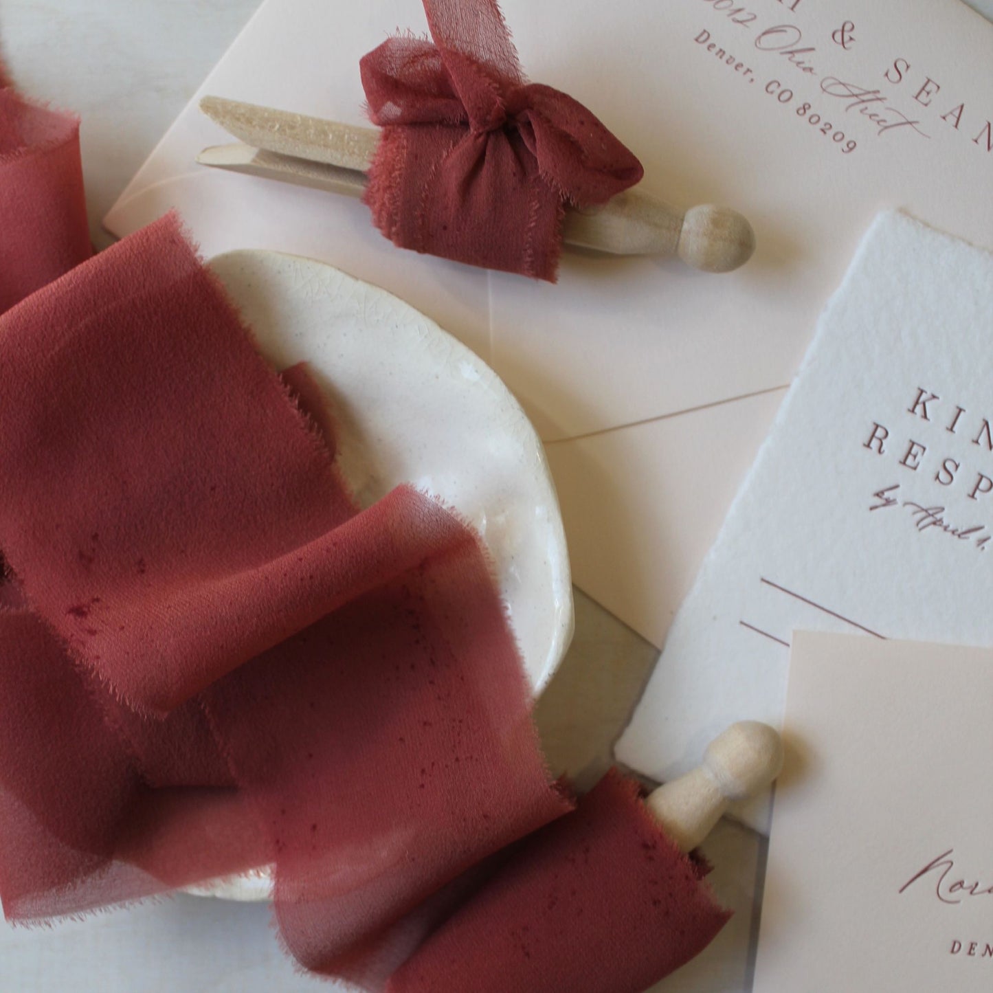 Naturally dyed red rust silk ribbon in warm earthy tones, styled for weddings