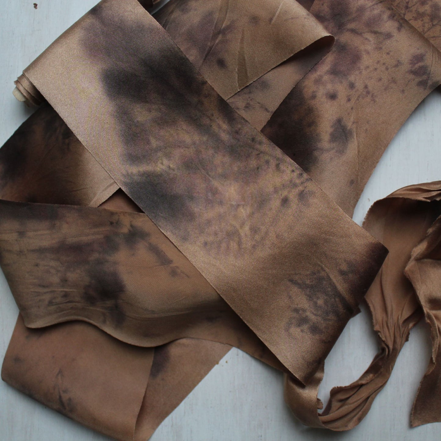 Close-up of silk charmeuse ribbon with leaf motif print