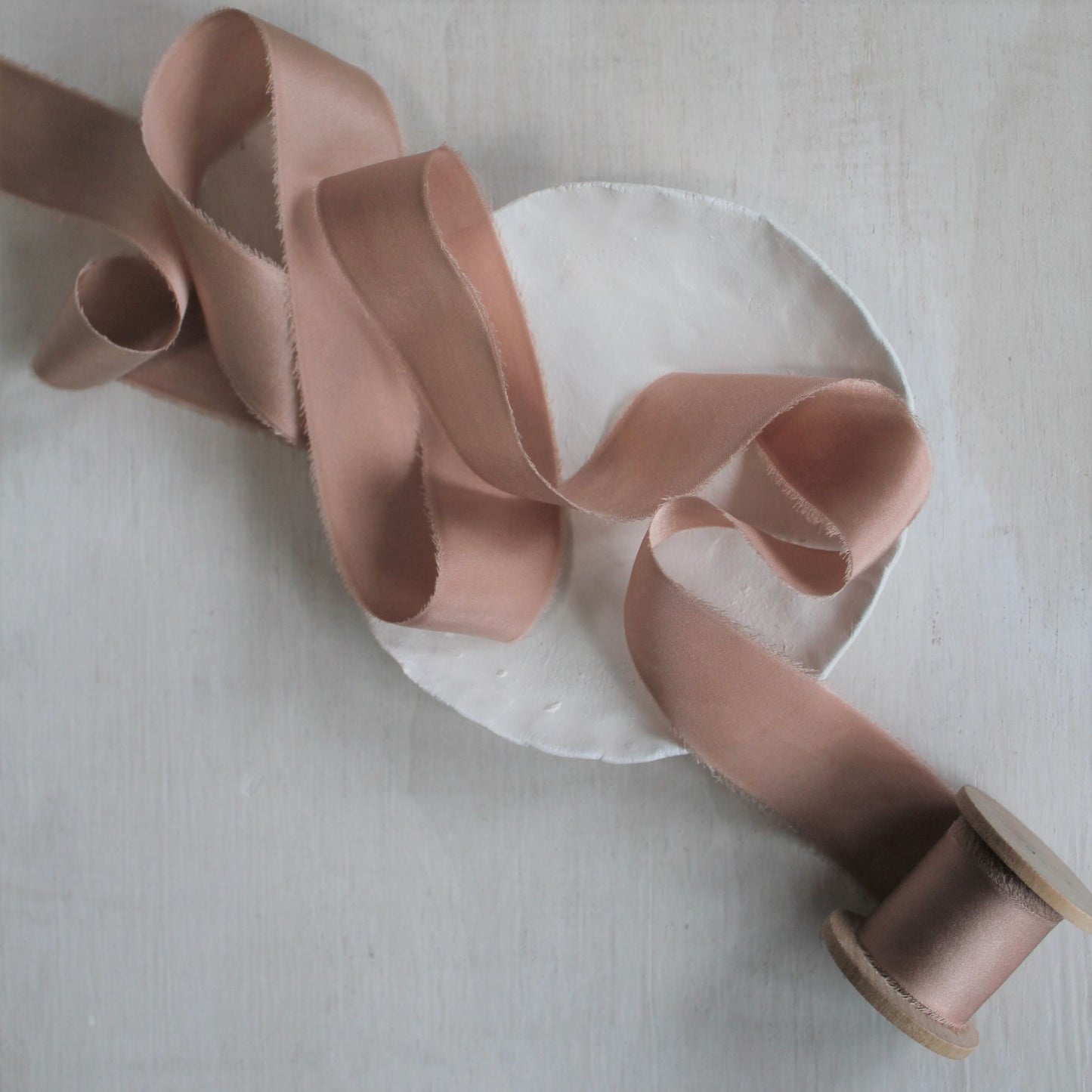 Full view of dusty rose silk charmeuse hand-torn ribbon.