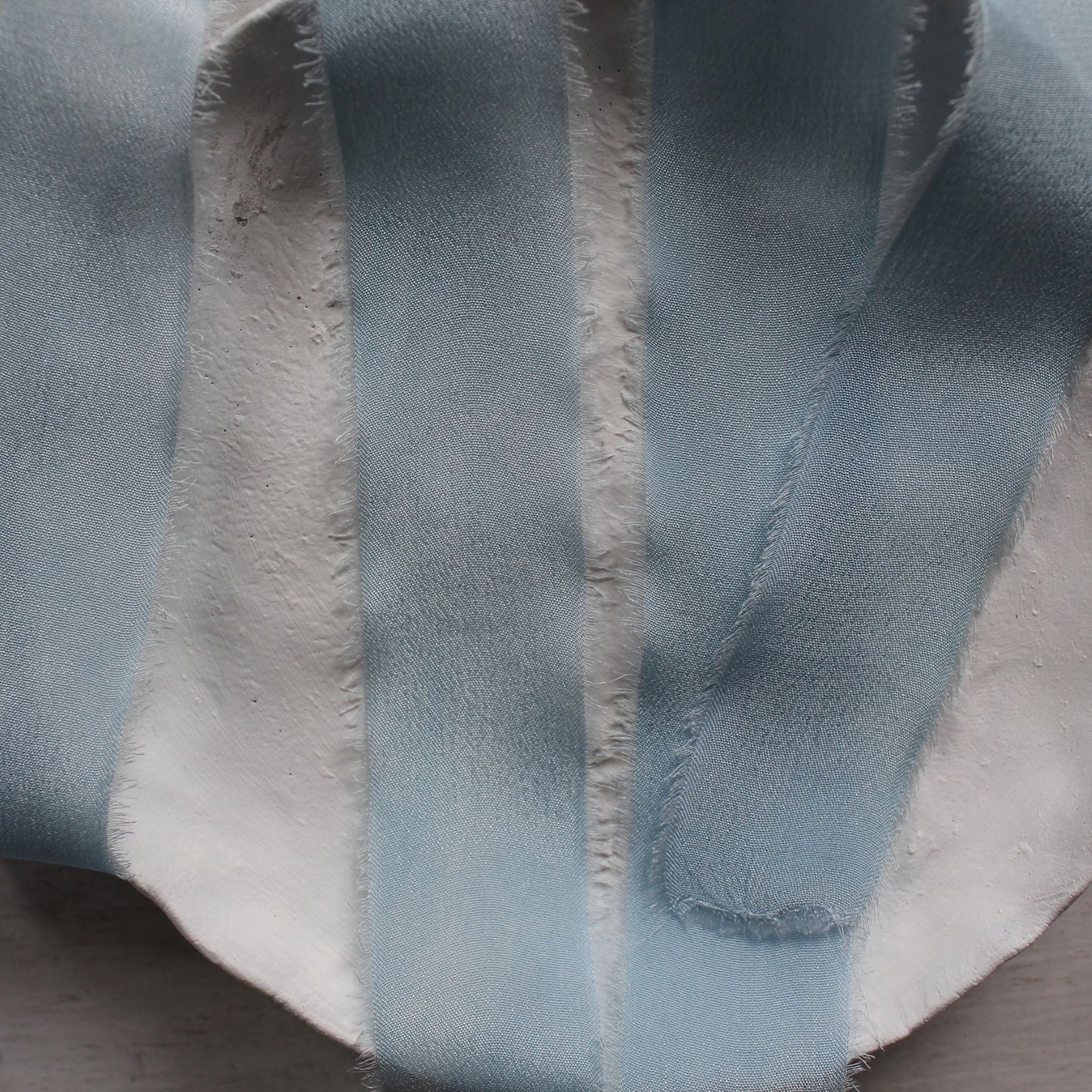 Soft pale blue silk ribbon with feathered edges