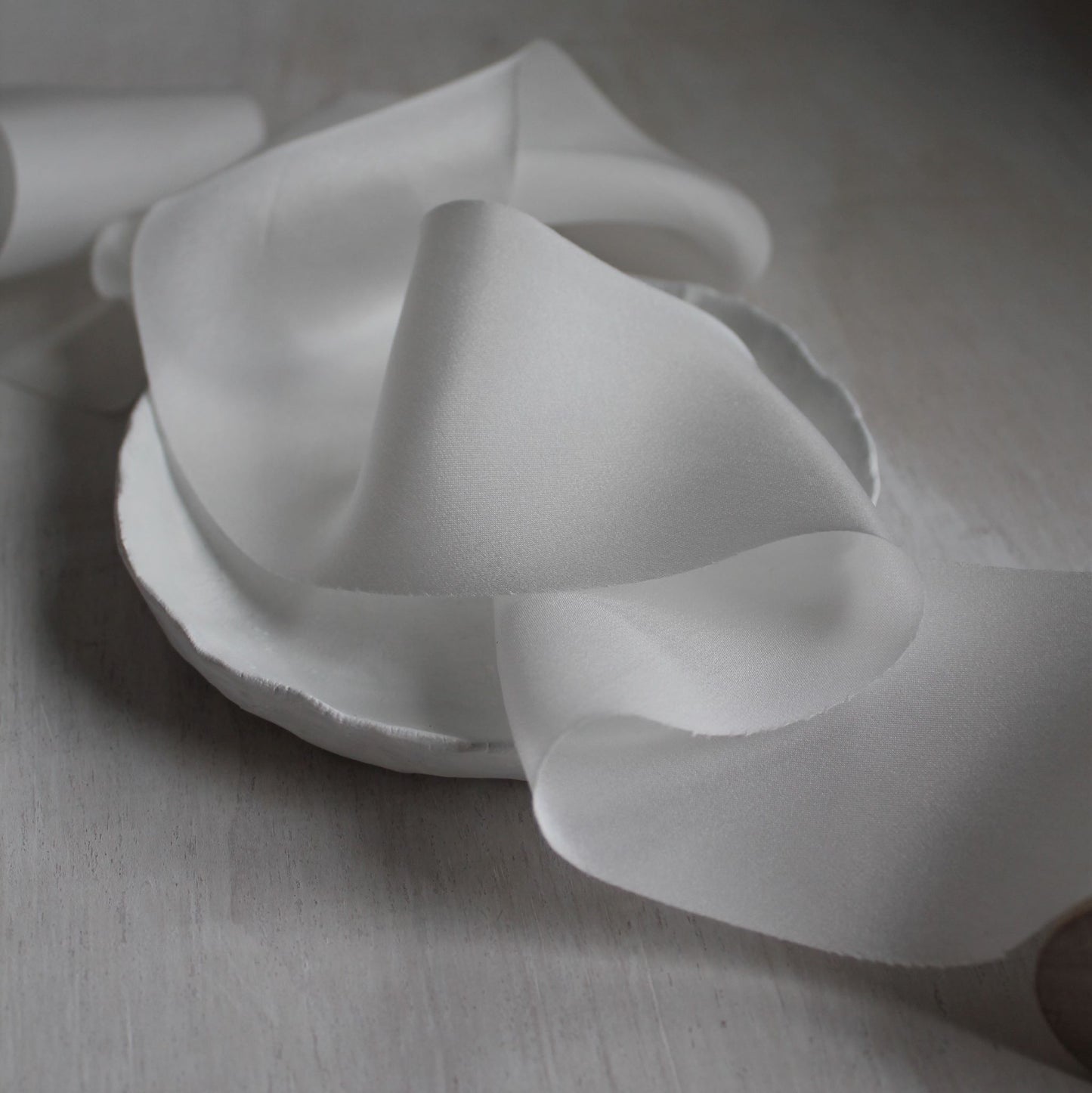 White silk charmeuse ribbon gently draped in folds