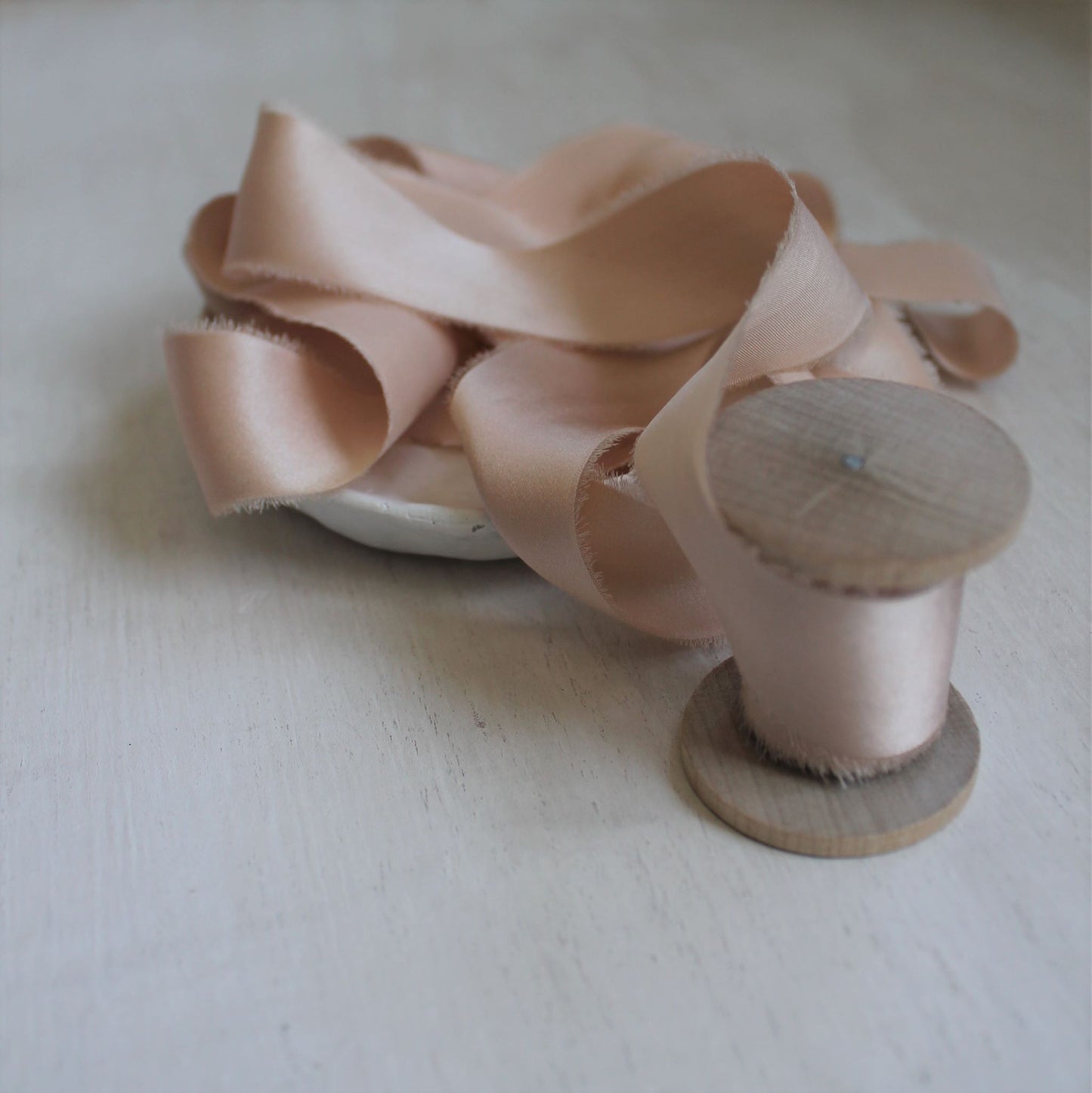 Charmeuse silk ribbon in light pink, styled for wedding stationery