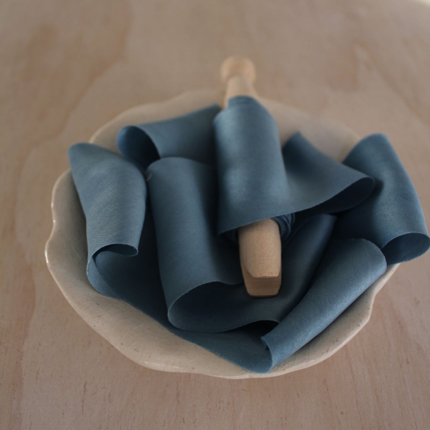 Blue silk charmeuse ribbon bias cut, handmade in Canada, perfect for luxury weddings and stationery. No seams, 100% natural indigo.