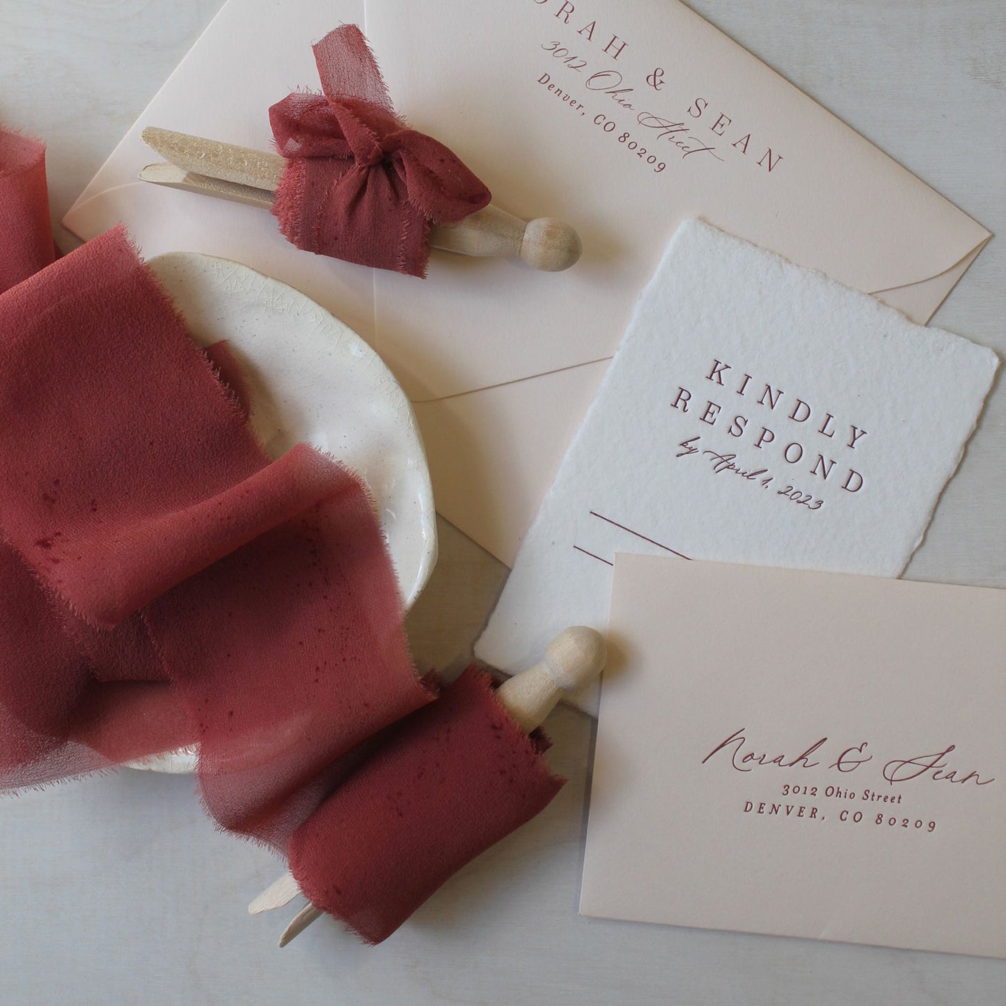 Hand-dyed chiffon silk ribbon in a rich red rust shade, shown in soft natural light