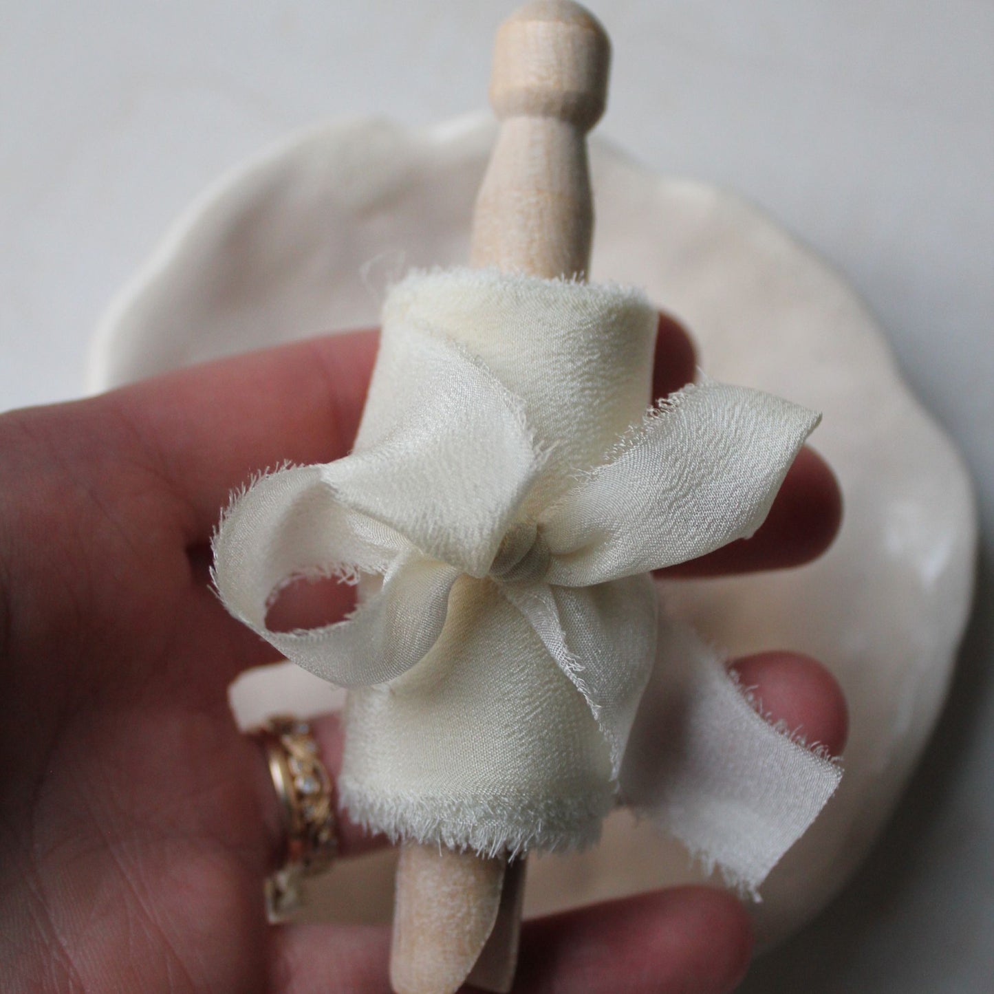 Delicate, hand-torn off-white silk ribbon used in wedding flat lays and luxury invitation styling