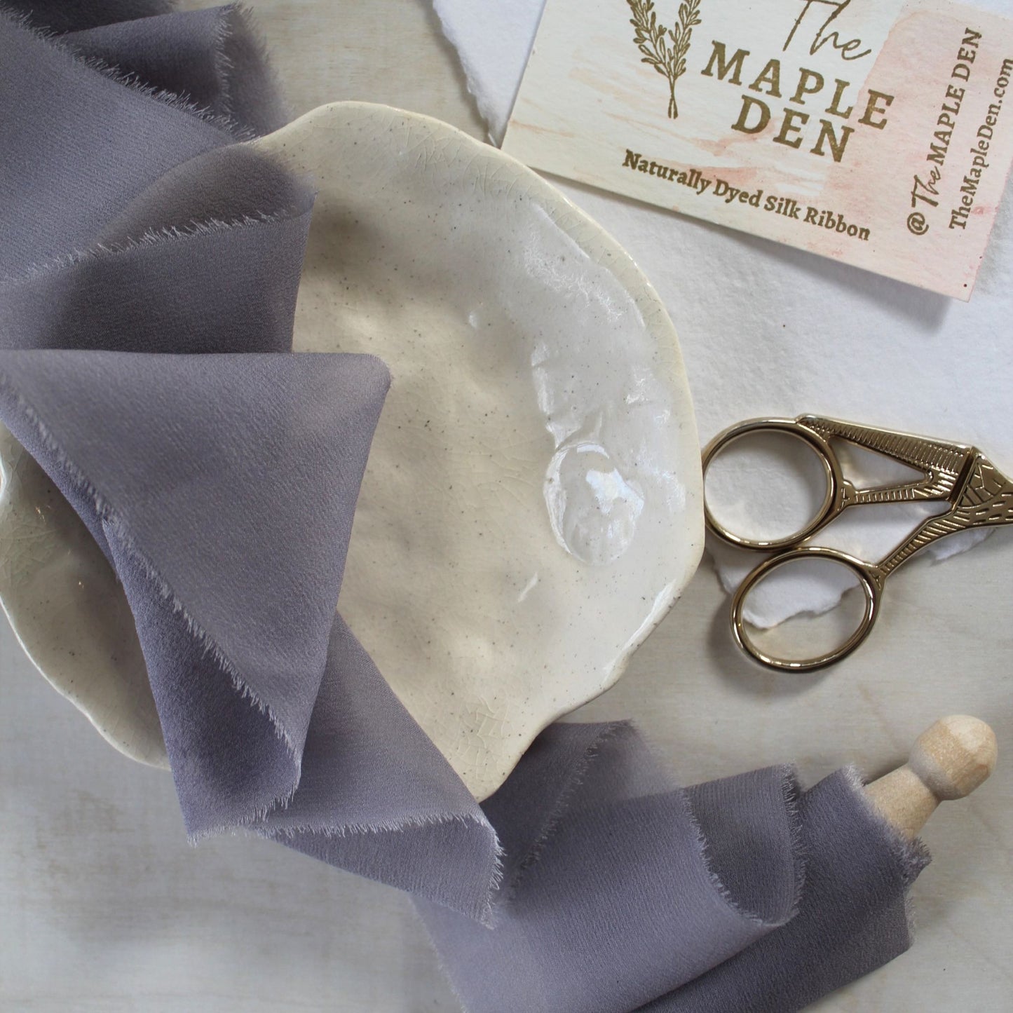Lavender Mist silk chiffon ribbon styled in a flat lay with wedding accessories.