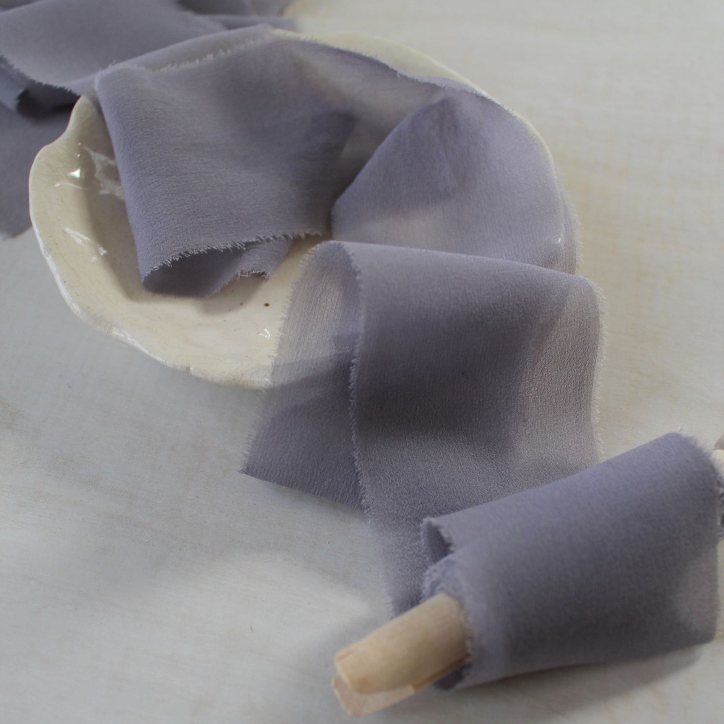 Close-up of mauve-lilac silk chiffon ribbon showcasing its sheer texture.
