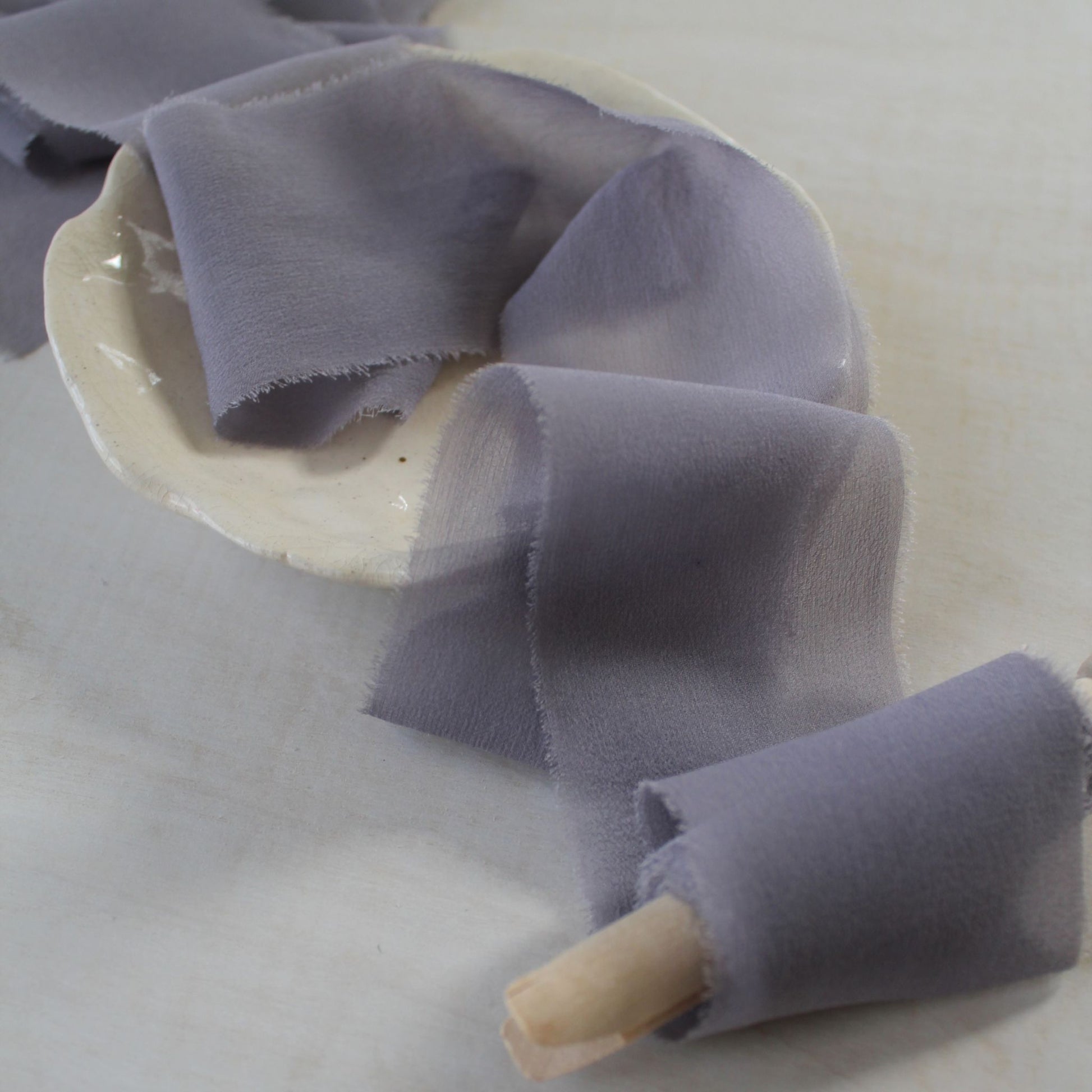 Close-up of mauve-lilac silk chiffon ribbon showcasing its sheer texture.
