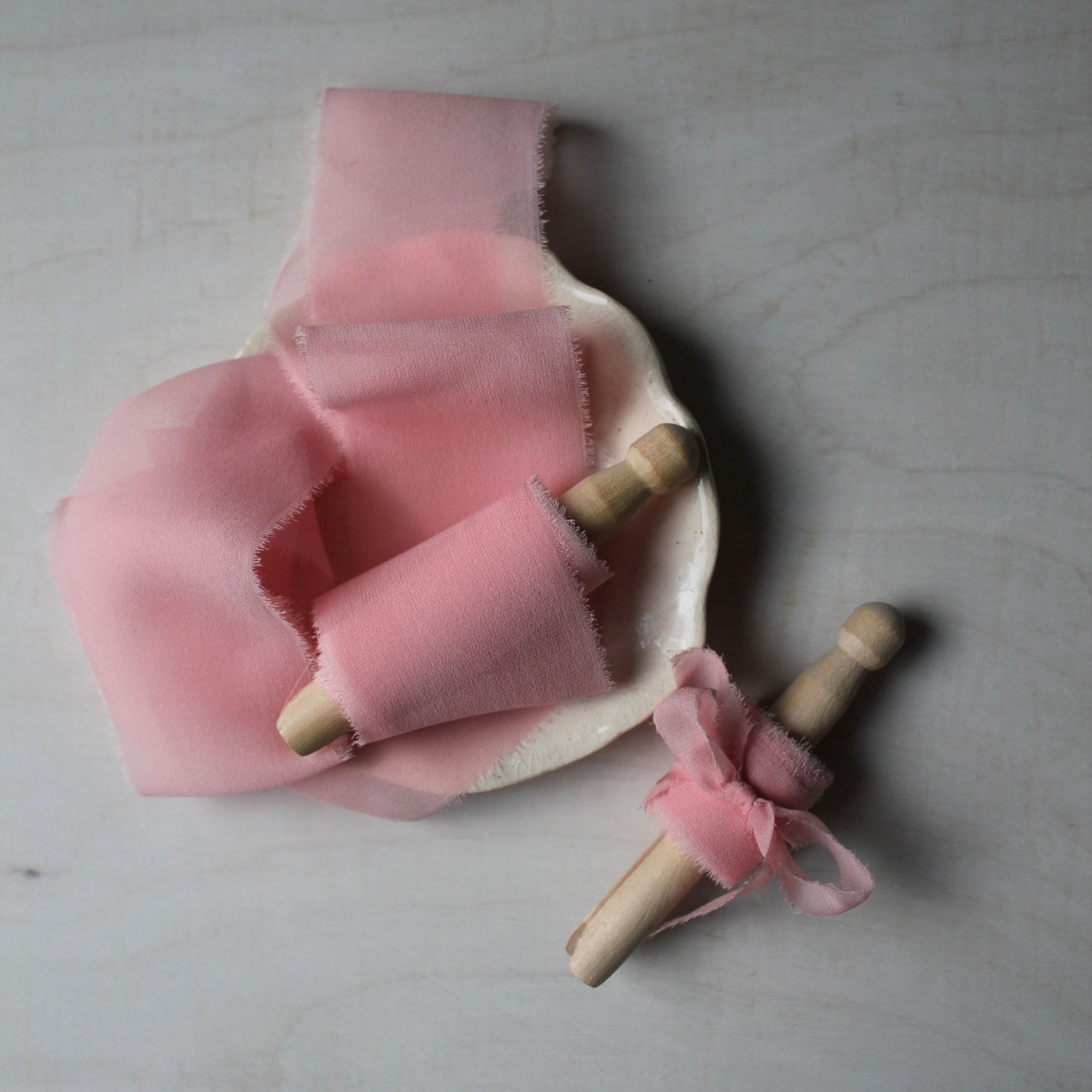 Elegant iridescent pink silk chiffon ribbon, hand-torn for a rustic yet refined touch to wedding bouquets and bridal accessories.
