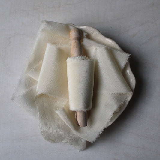 Off-white crepe de chine silk ribbon, hand-torn and naturally dyed, perfect for Canadian weddings and elegant stationery.