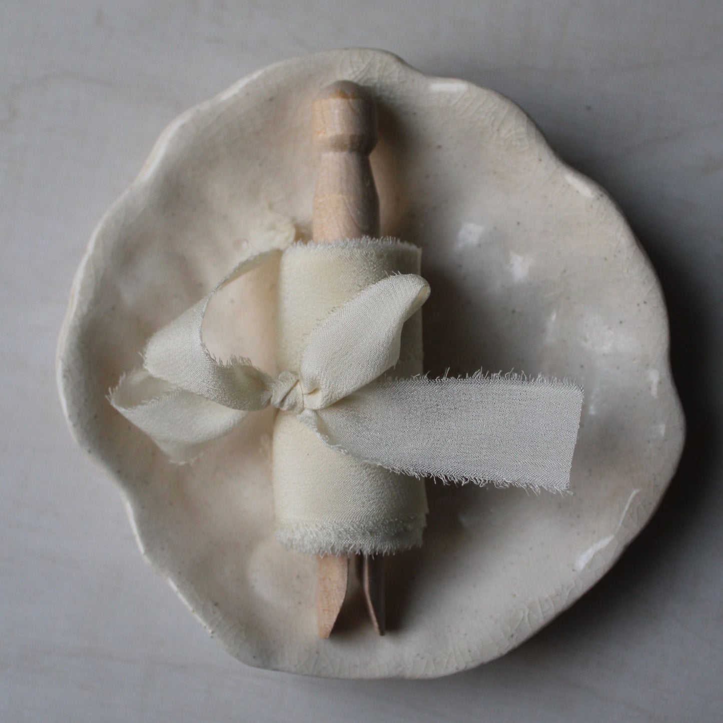 Off-white wedding ribbon made from crepe de chine silk, hand-torn with frayed edges, ideal for refined Canadian weddings, wood clothes peg with a bow