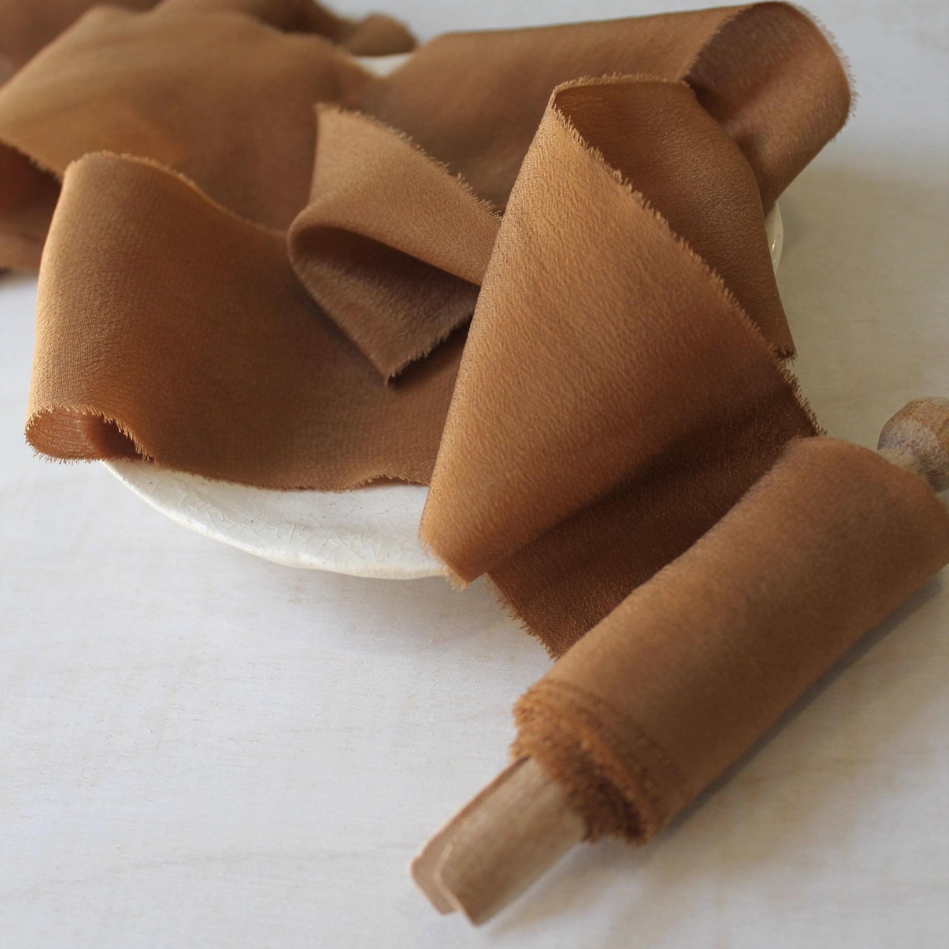 Close-up of artisanal silk ribbon for wedding stationery