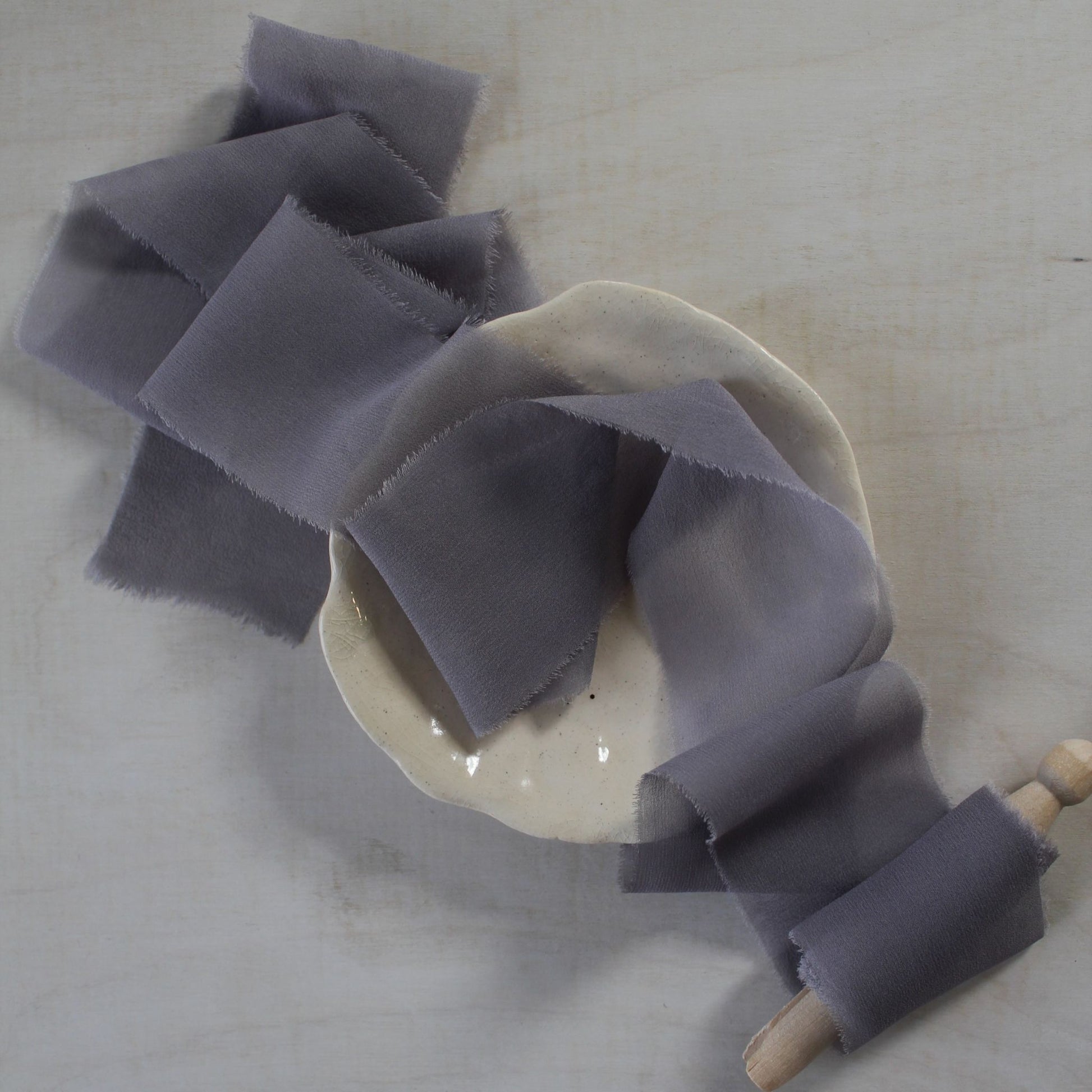 Lavender Mist ribbon cascading over a rustic wooden surface.