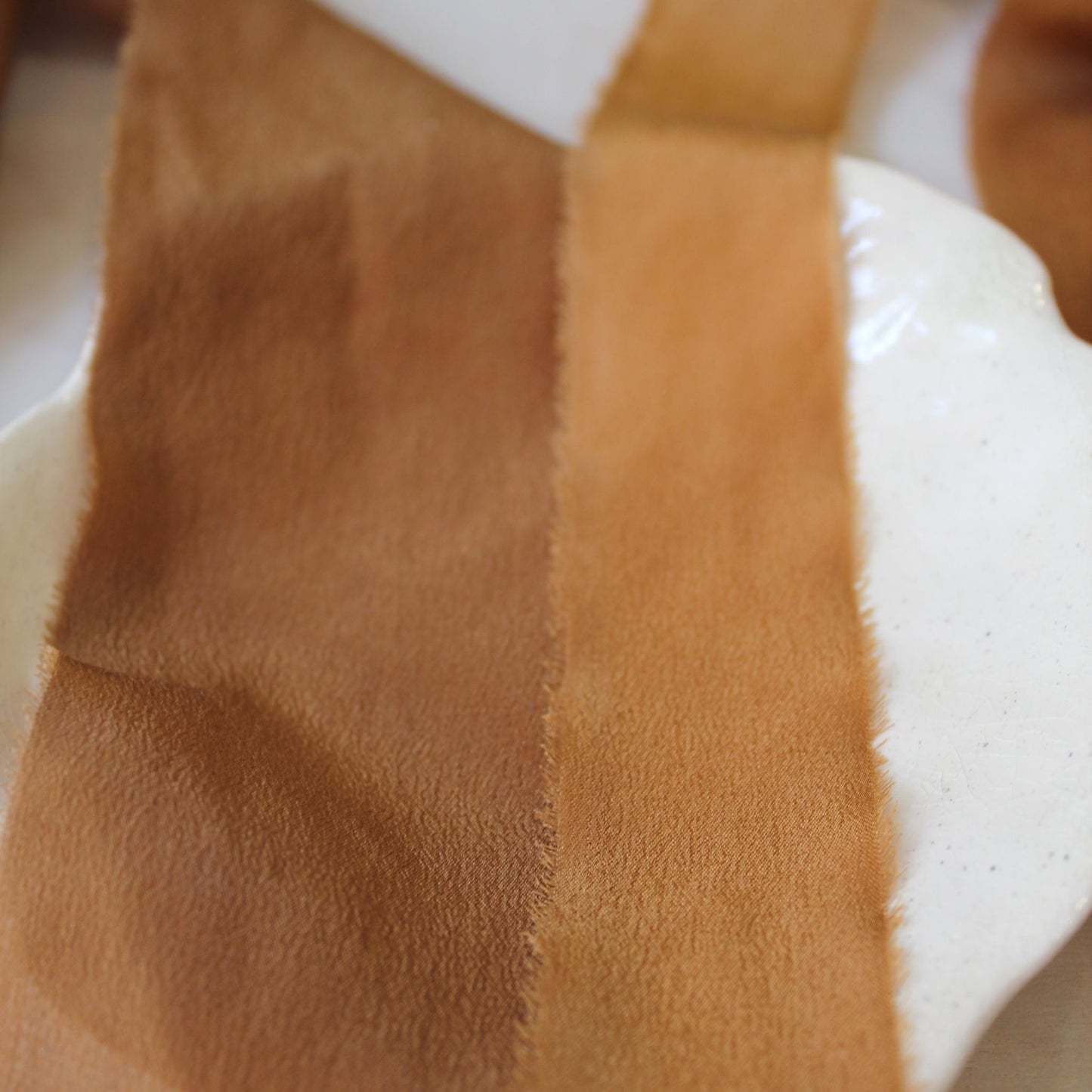 Crepe silk ribbon in earthy rust tone for flatlay styling colour variations