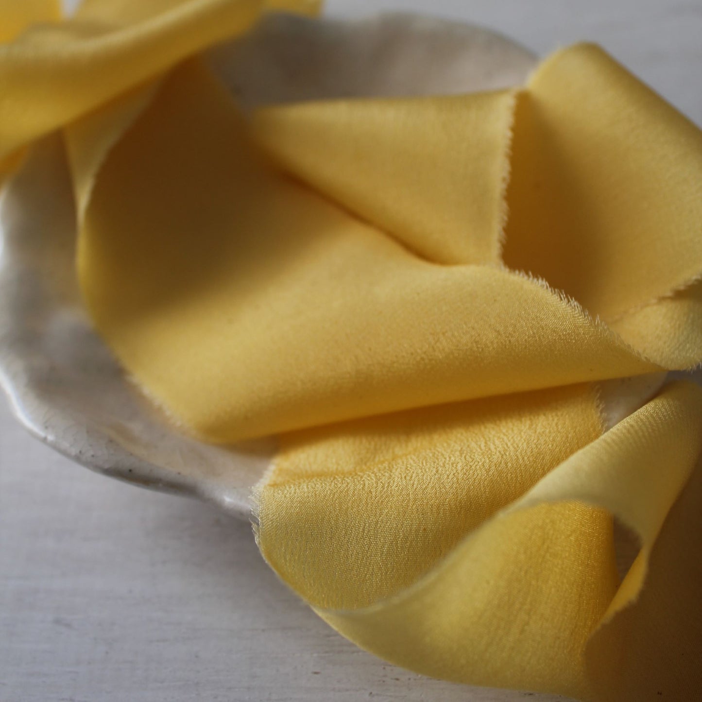 close up of yellow silk ribbon naturally dyed by hand in canada