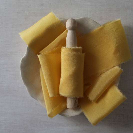 yellow silk ribbon on wood clothes peg