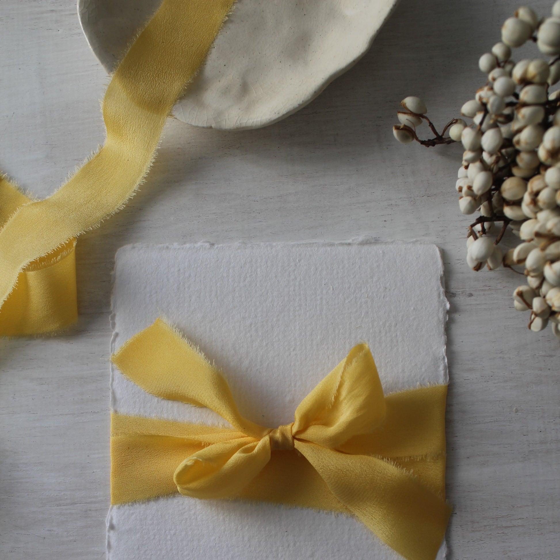 hand torn yellow silk ribbon tied around handmade paper perfect for weddings, floral styling and gift wrapping