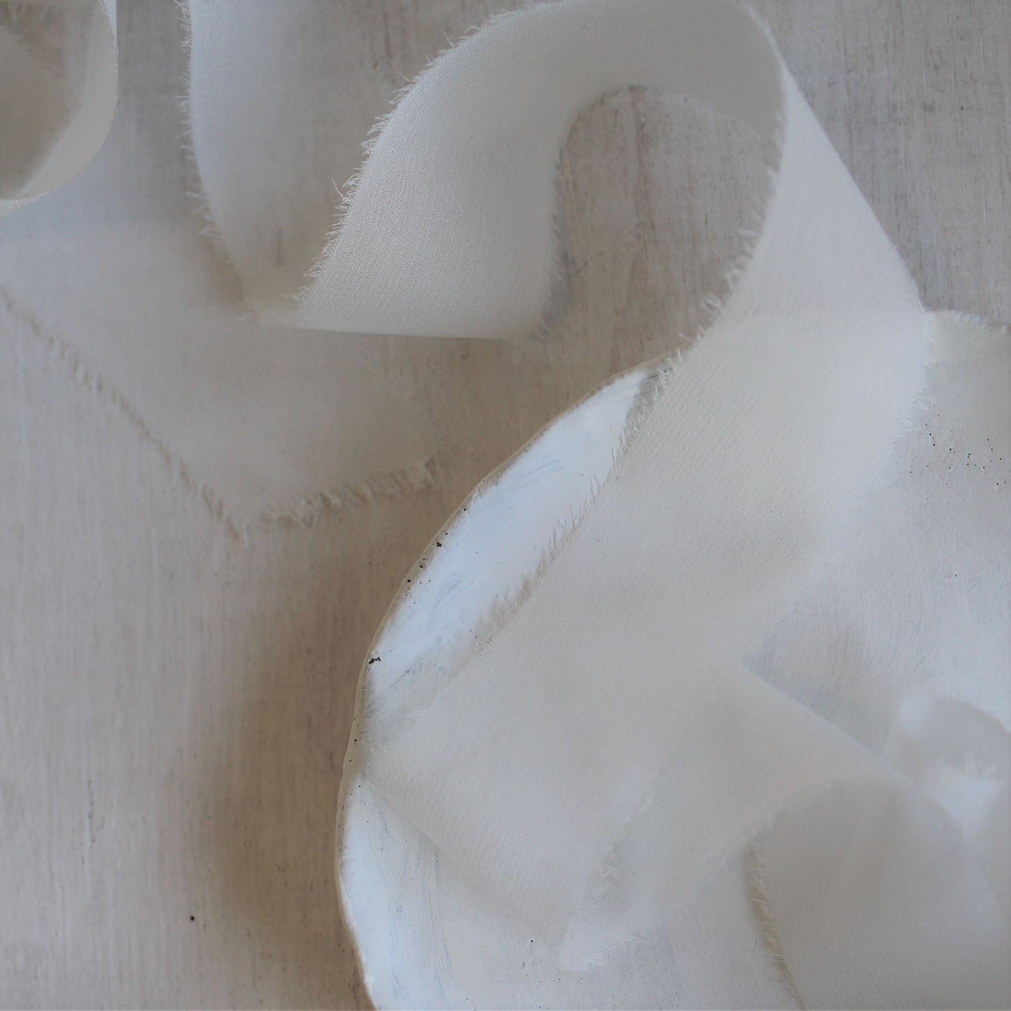 Close-up of airy texture and raw edge on chiffon silk