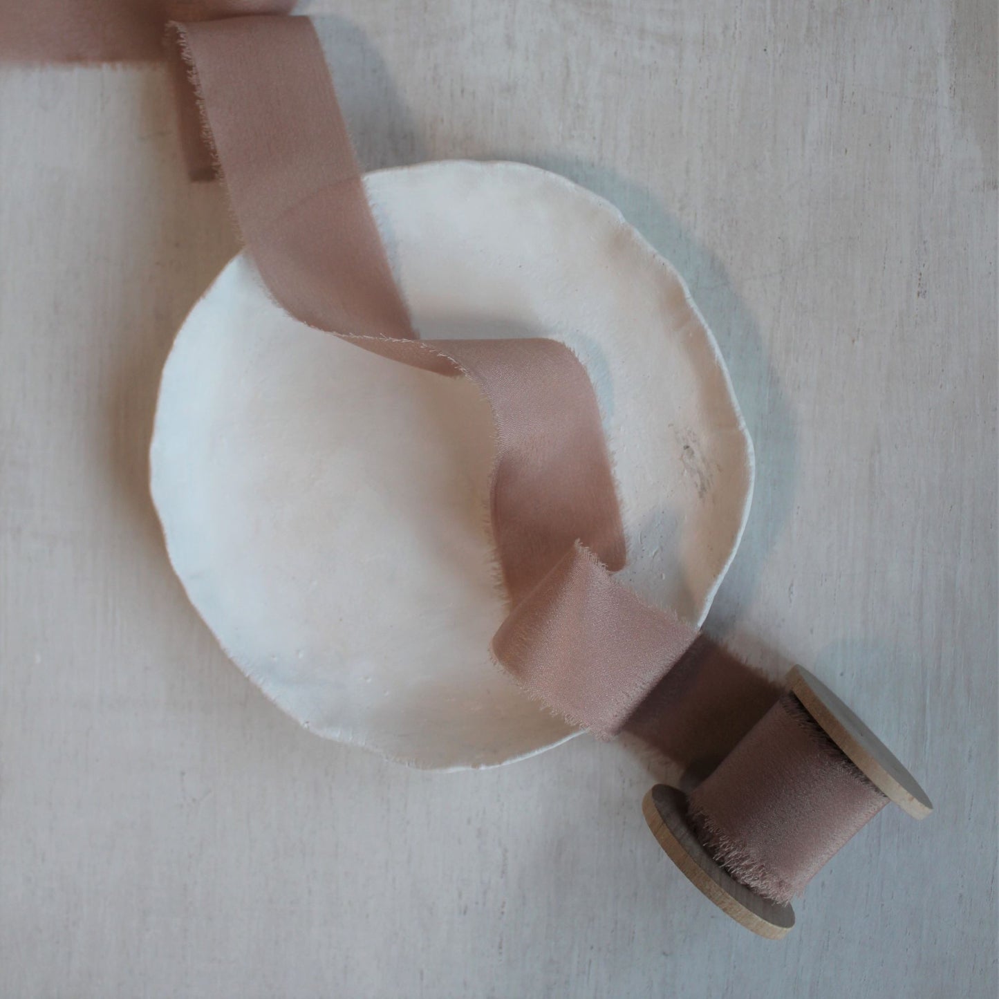 Dusty rose wedding ribbon on wood spool, handcrafted in Canada