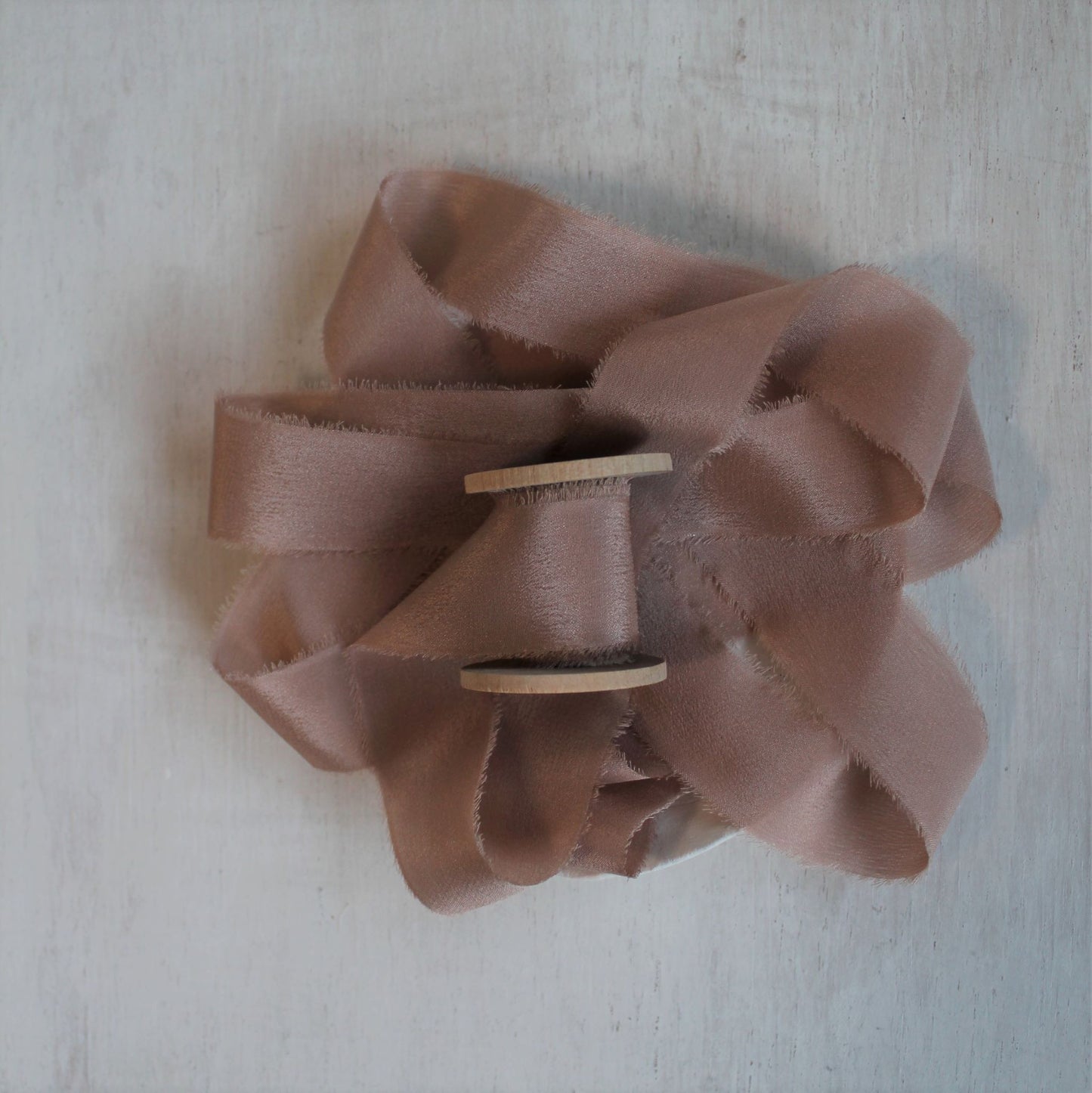 Dusty rose wedding ribbon on wood spool on inch wide