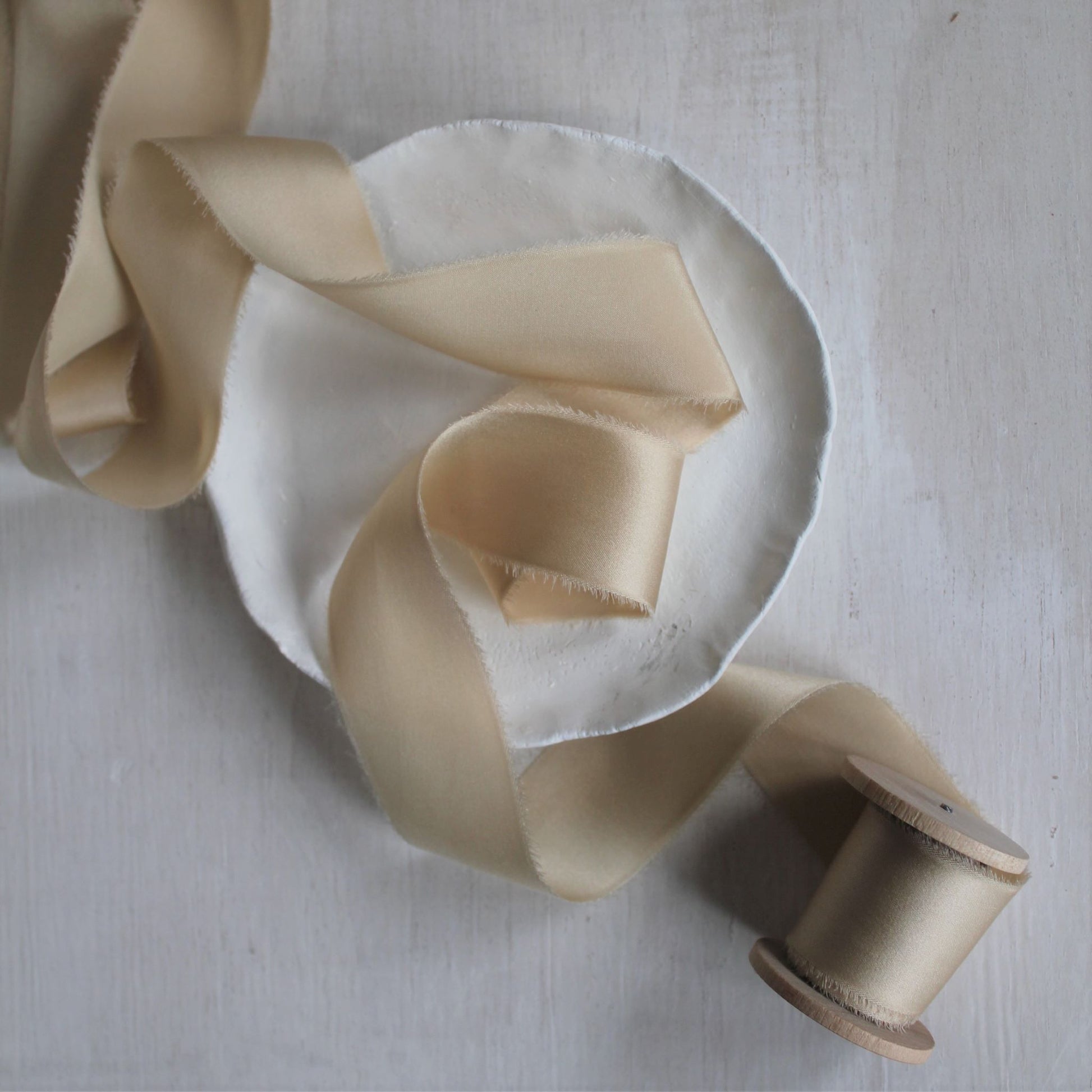 Hand-torn maple silk charmeuse ribbon with a luxurious feel, perfect for bouquet wraps and fine art styling.