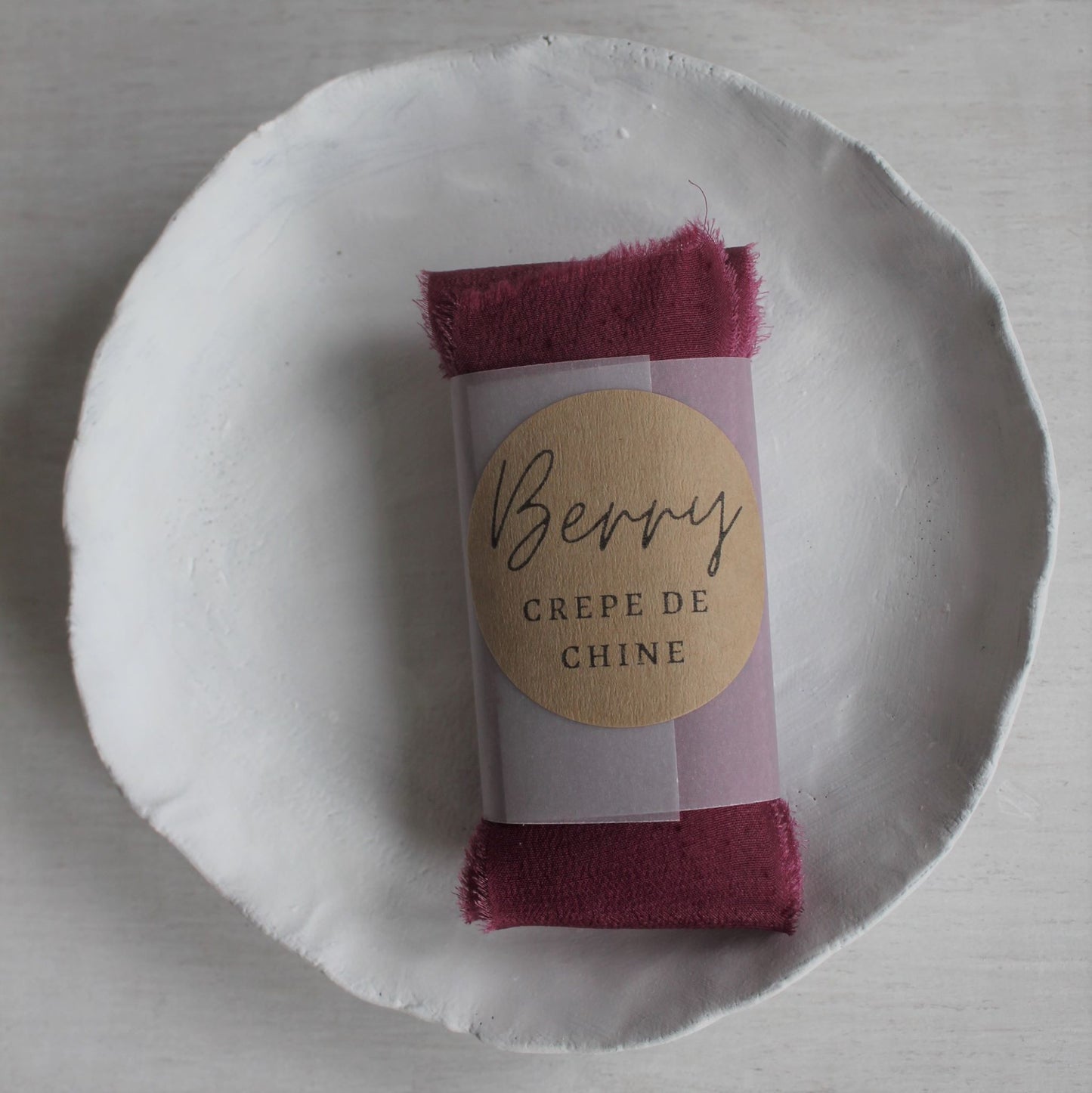 Canadian-made hand-dyed berry silk crepe de chine ribbon for bridal and stationery designs shown folded for lettermail shipping
