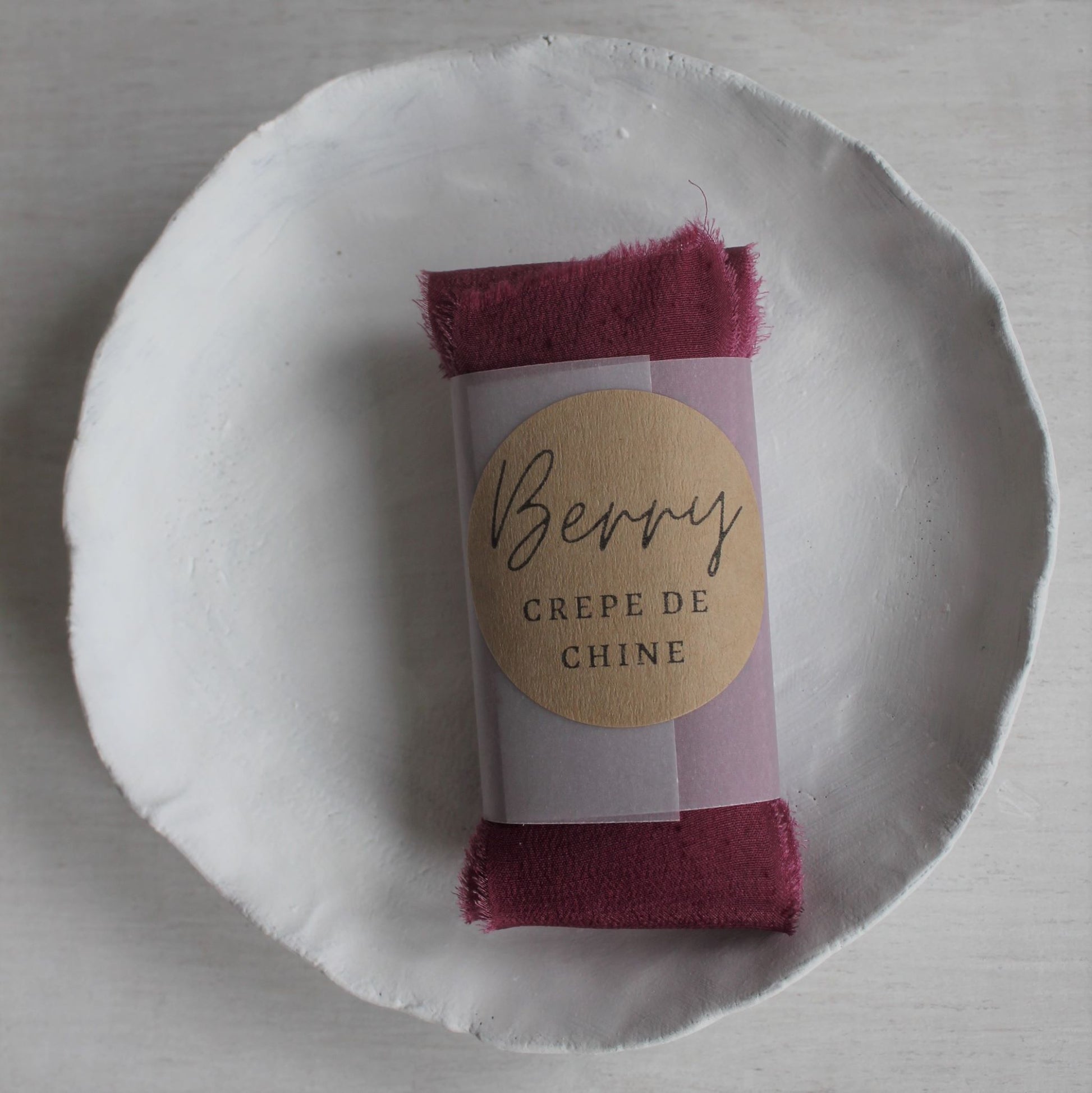 Canadian-made hand-dyed berry silk crepe de chine ribbon for bridal and stationery designs shown folded for lettermail shipping