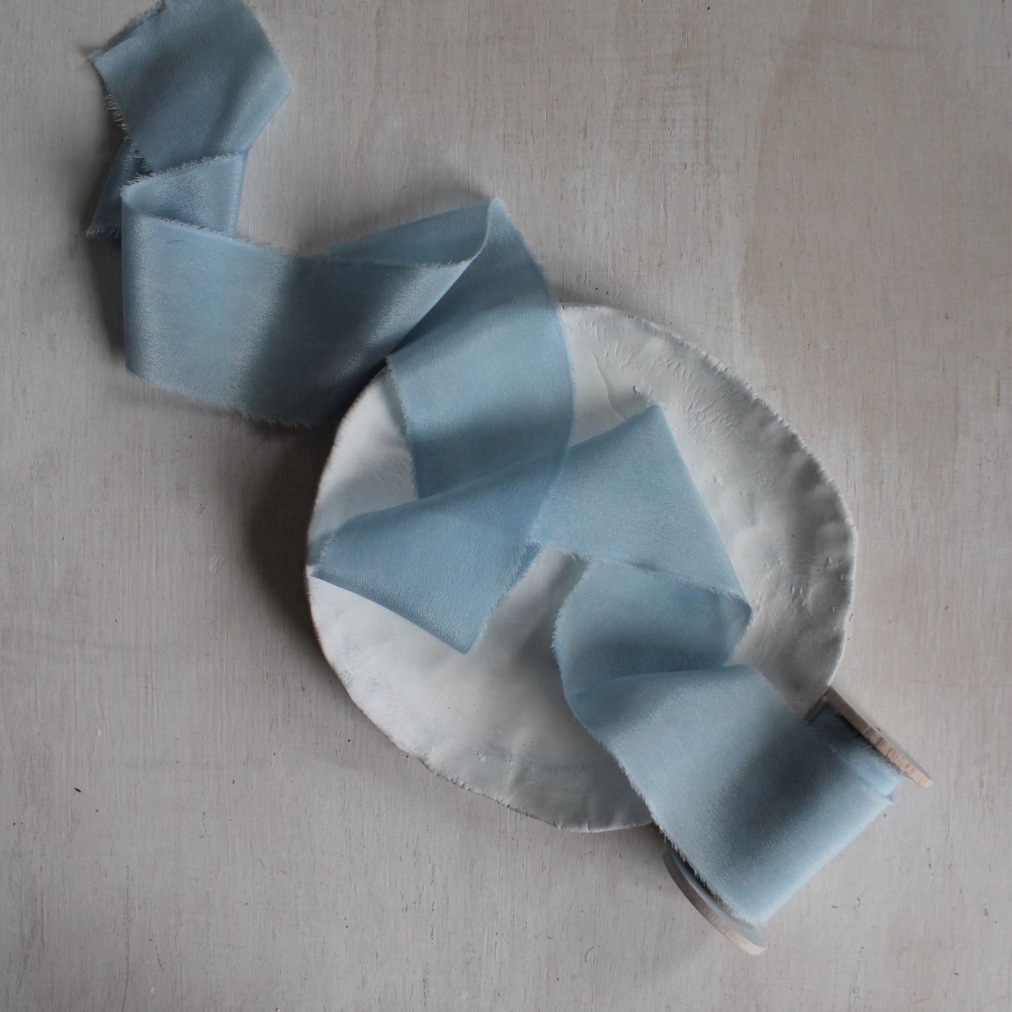 Hand-dyed silk ribbon in light indigo blue for weddings or crafts two inch on wood spool