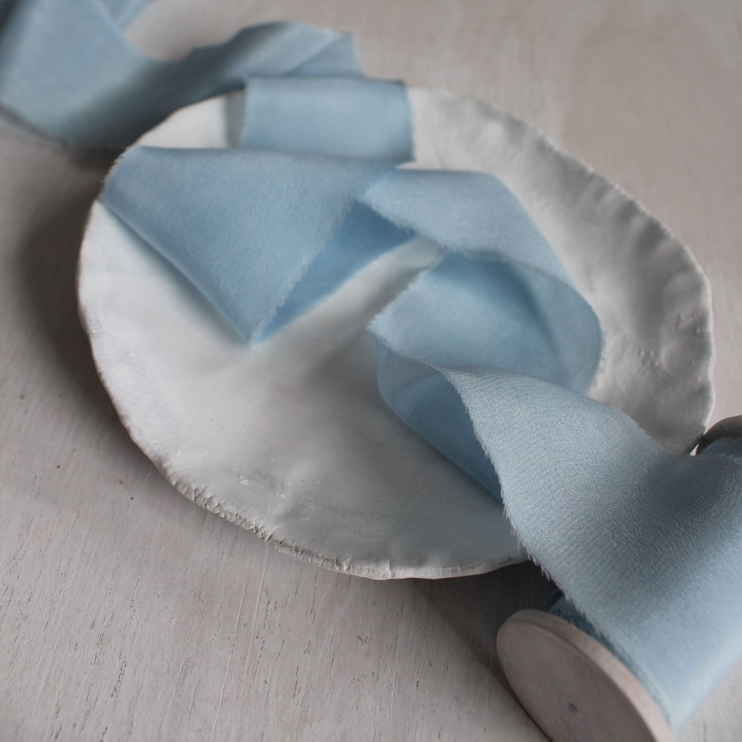 Close-up of crepe silk ribbon texture in indigo-dyed blue