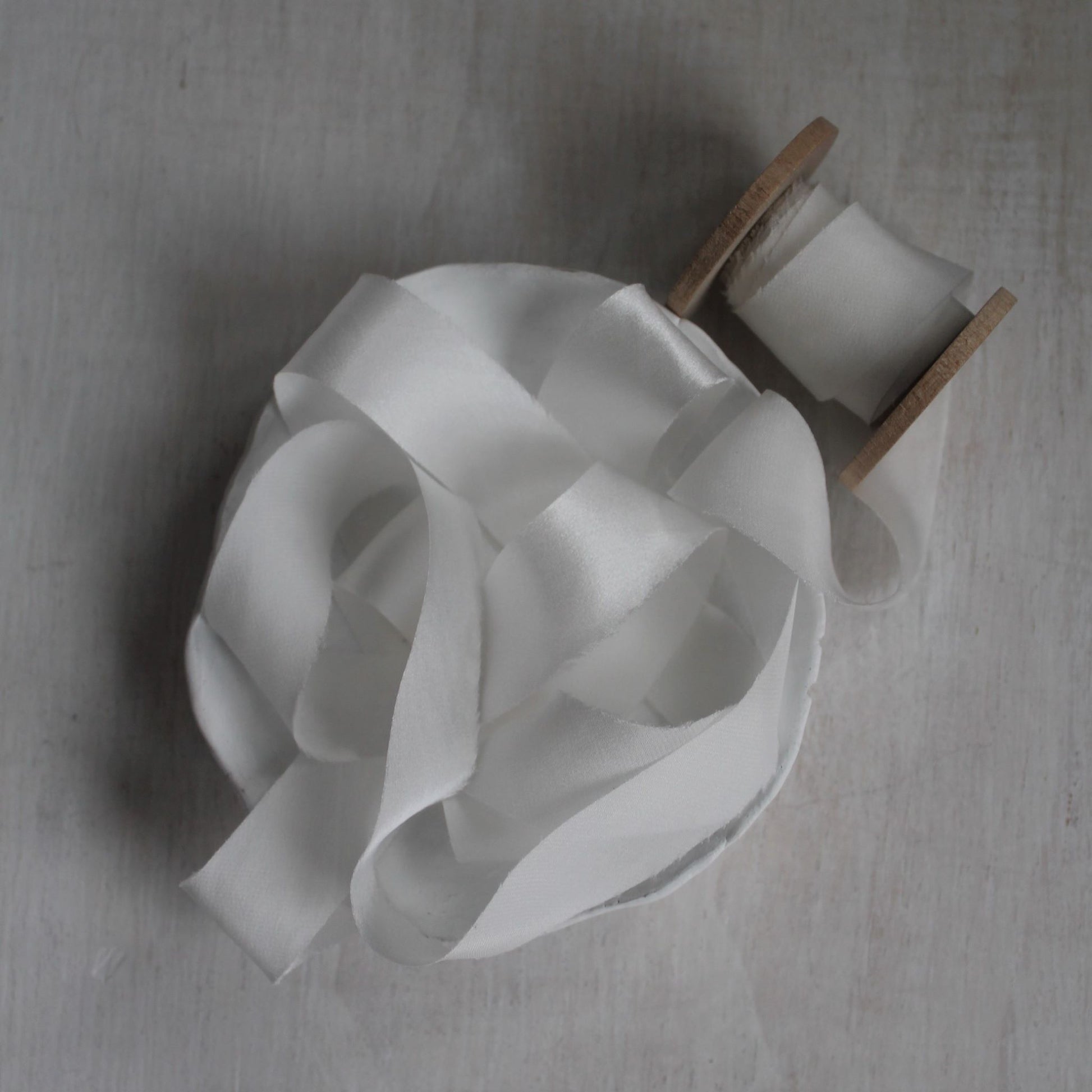 Bias-cut white ribbon edge detail highlighting clean cut