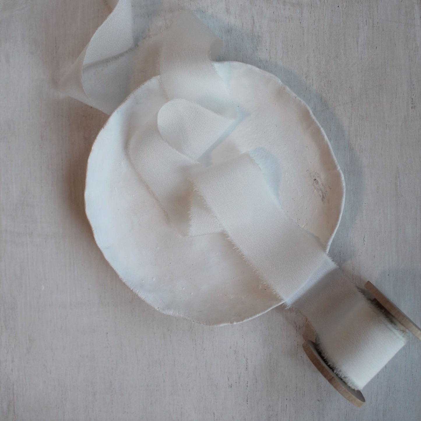 One-inch silk ribbon displayed on a wooden background