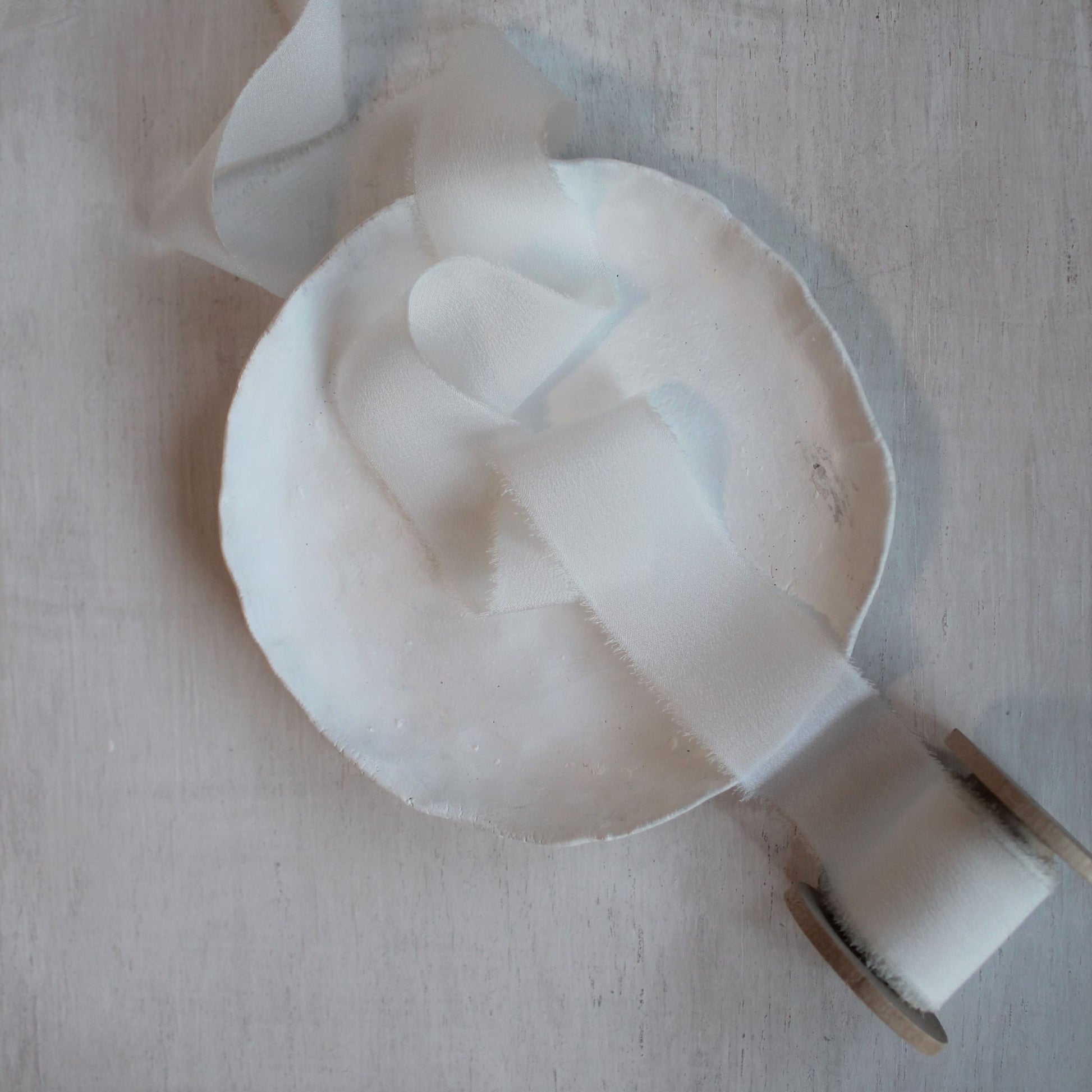 One-inch silk ribbon displayed on a wooden background