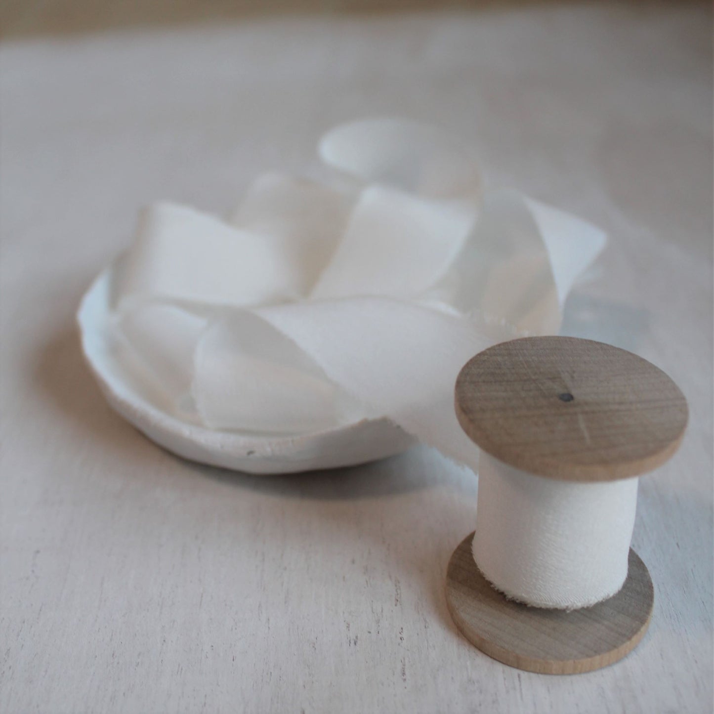 One-inch crepe de chine ribbon on a rustic wood spool