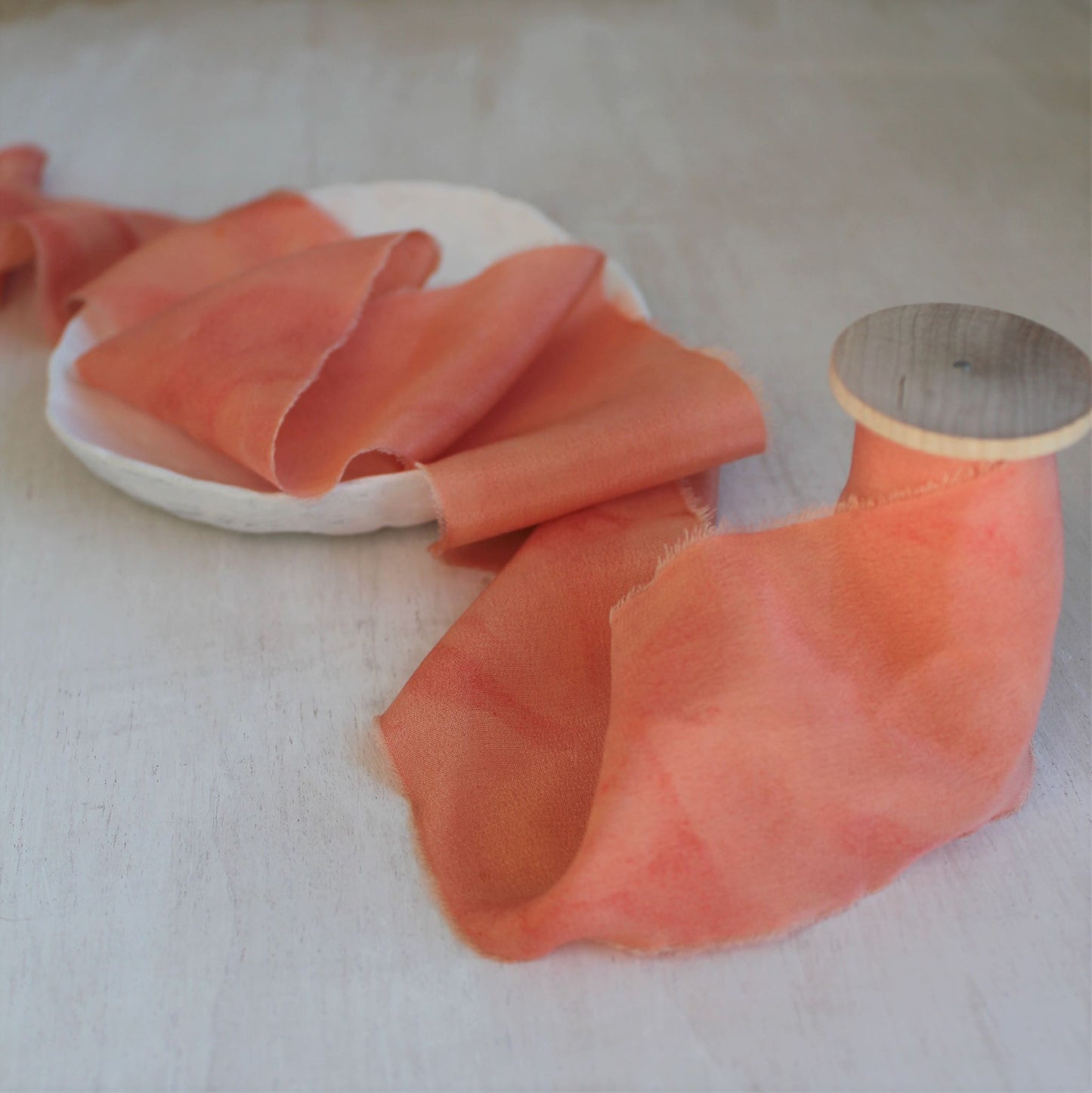 Hand-dyed salmon silk ribbon in crepe de chine, 3 yards long, hand-torn for a rustic, elegant look.