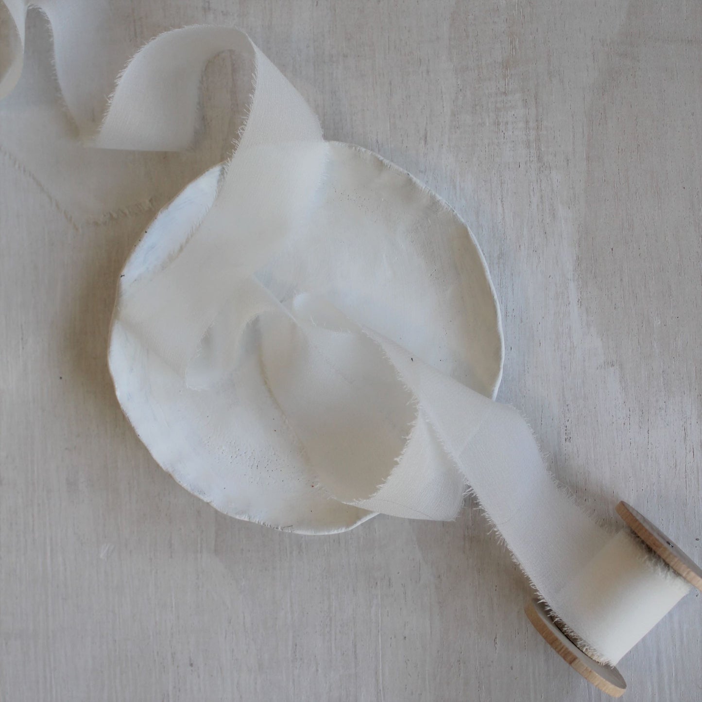 Delicate white ribbon hand torn for organic texture