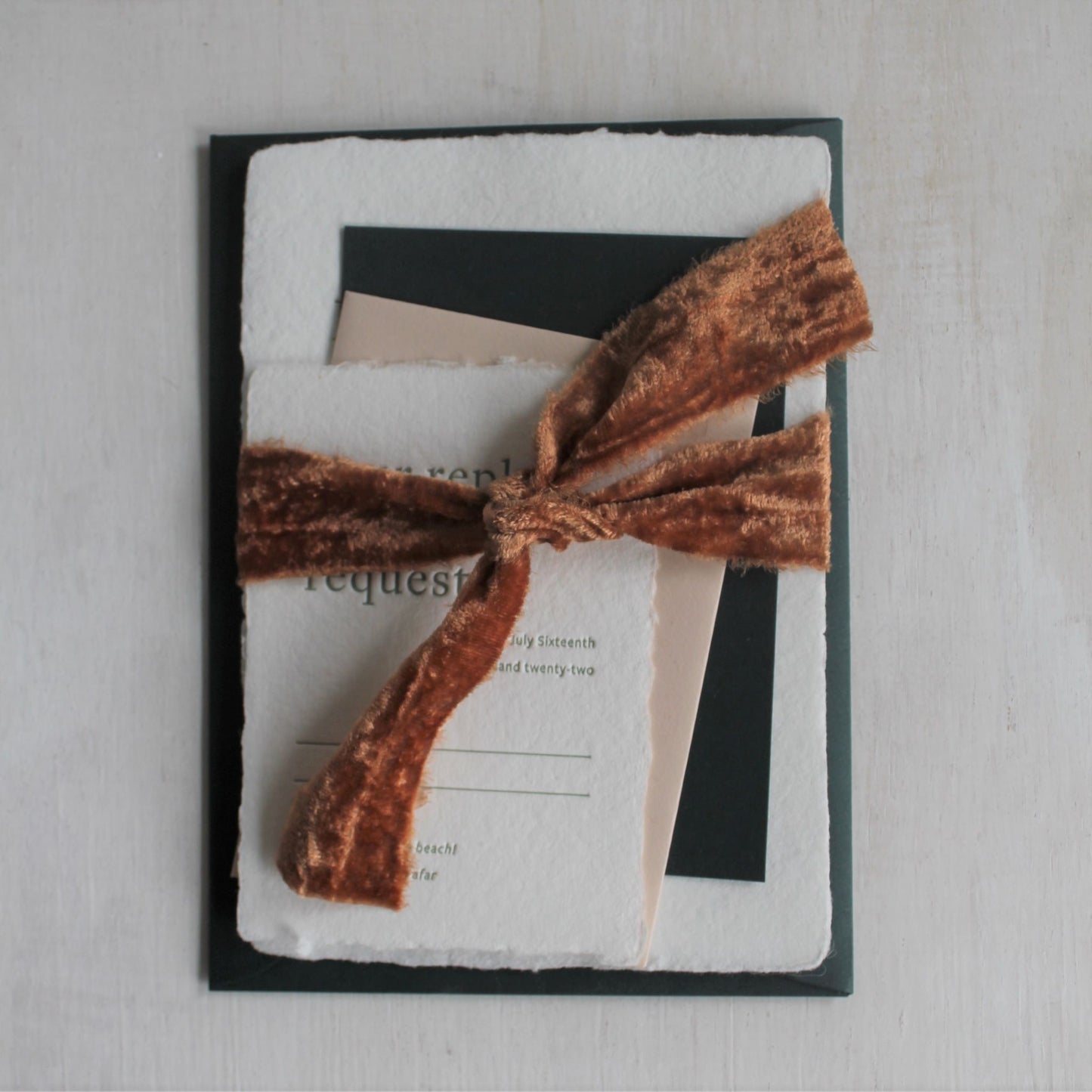 Terra cotta velvet ribbon paired with wedding stationery