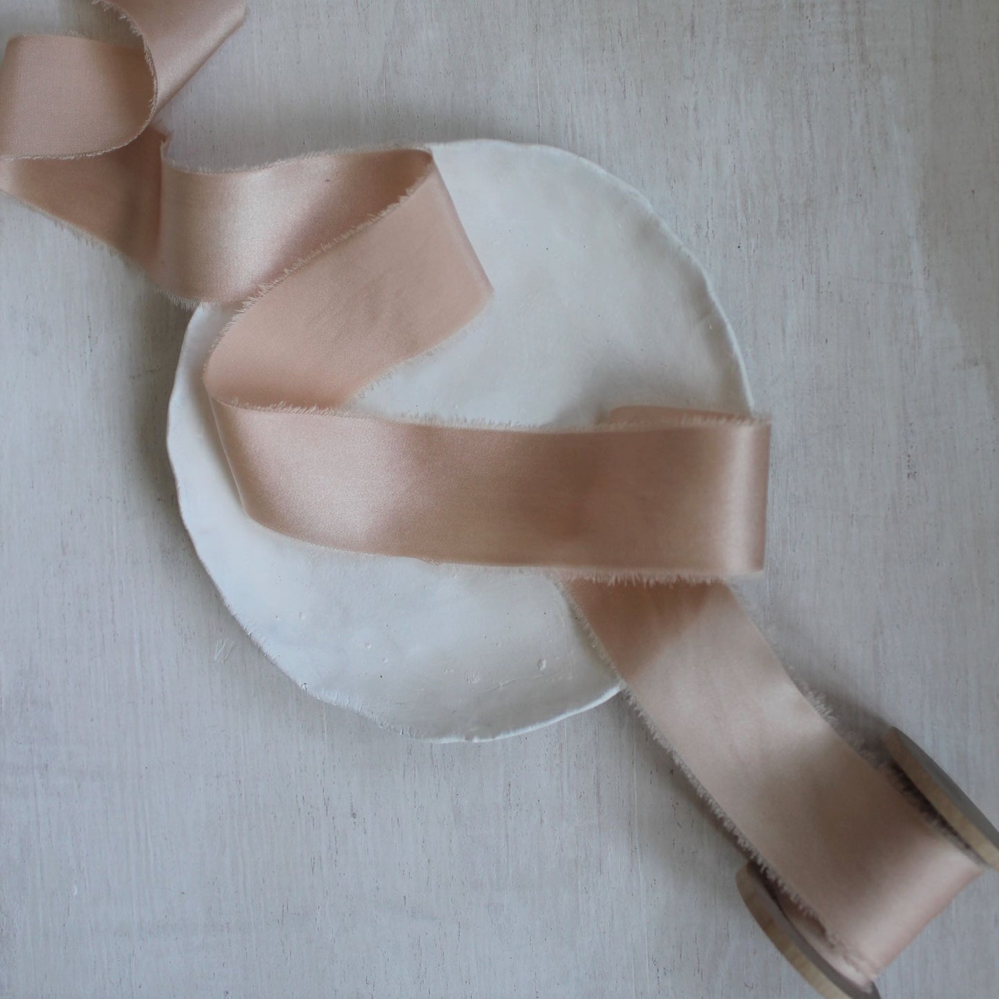 Close-up of handmade pink ribbon with soft sheen