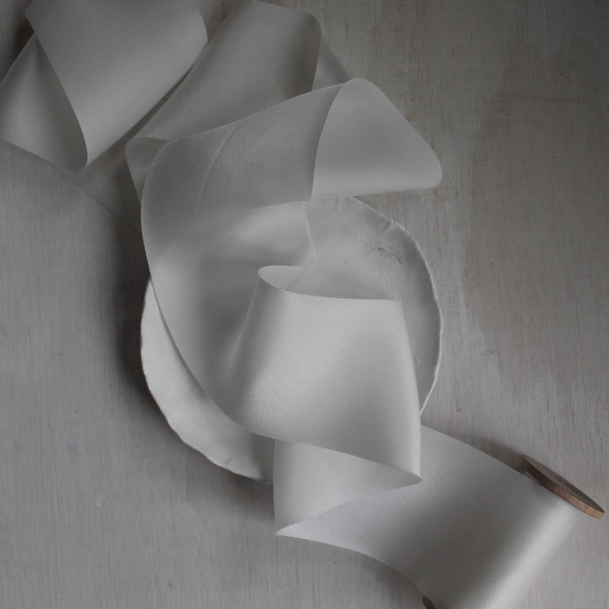 White silk charmeuse ribbon gently draped in folds